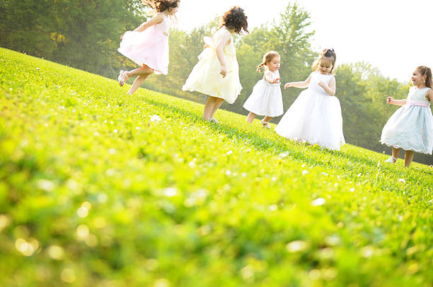 Five Little Girls Dancing and Spinning in the Grass
