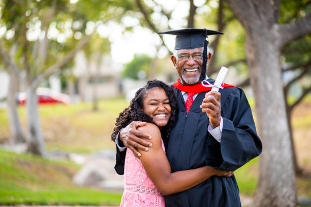 istock Senior black man at graduation with his daughter 1082037938