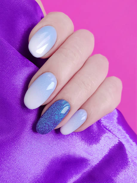 istock female hands beautiful manicure, silk fabric 1082040892