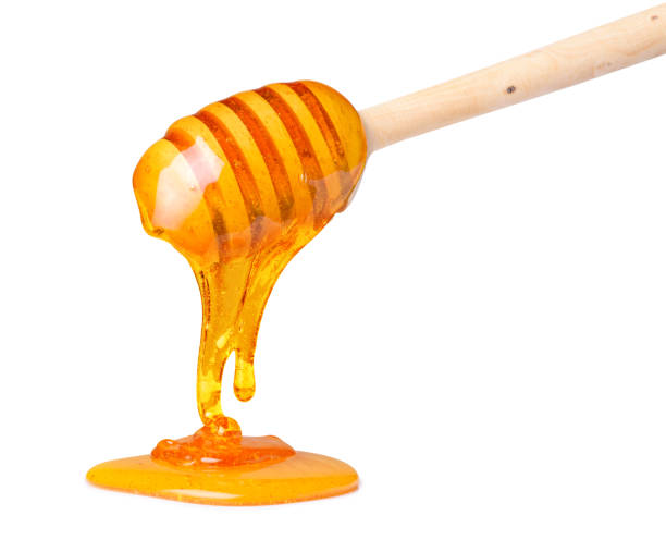 istock Honey slowly dripping from the honey spoon dipper 1082041076
