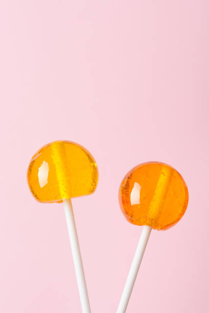 istock Lollipops on white plastic sticks on pink pastel background 1082041098