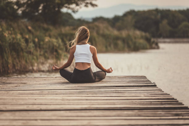 istock Young woman doing yoga meditation 1082043416