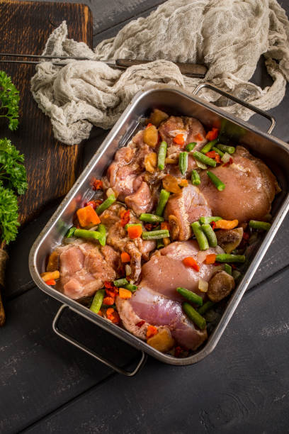 istock Prepared for baking chicken meat with vegetables. 1082061044