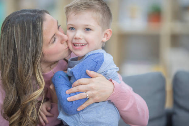 istock Mom kissing her son on the cheek 1082065294