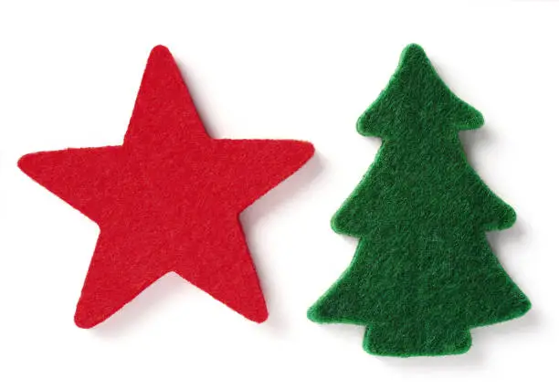 red felt star and green felt fir tree isolated over white background