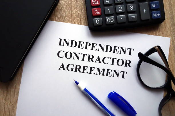 Independent contractor agreement, pen, glasses and calculator Independent contractor agreement, pen, glasses and calculator on desk independence document agreement contract stock pictures, royalty-free photos & images