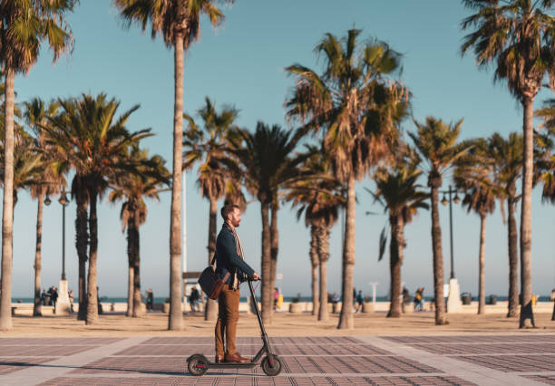 istock Businessman riding an electric push scooter on his way to work 1082074188