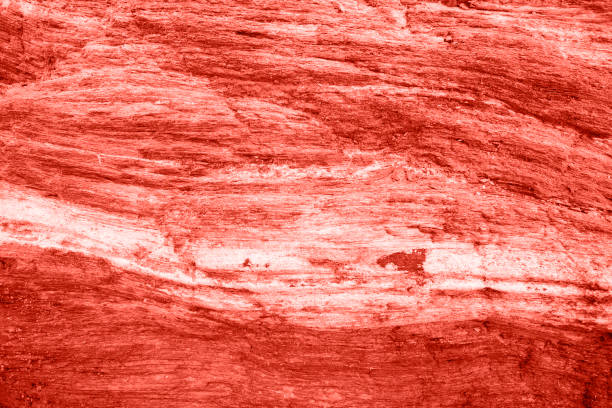 istock Living Coral color dark stone background. 1082079276