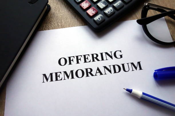 istock Offering memorandum document, pen, glasses and calculator 1082079840