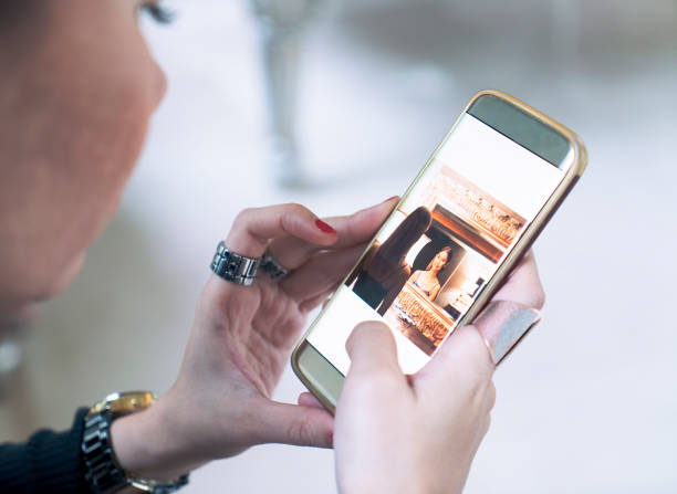 istock Woman using social media sharing picture on mobile phone 1082080082