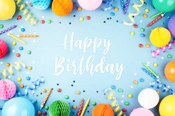 Birthday party background. Birthday party background with Happy Birthday greeting text on blue. Top view. Frame made of colorful serpentine, balloons, candles, candies and confetti. confetti star shape red yellow stock pictures, royalty-free photos & images