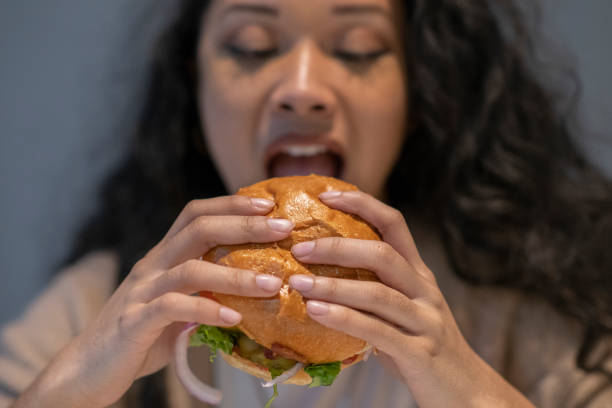 istock Girl eating a burger 1082091984