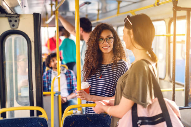istock Two girls talking while wait for bus to move. 1082093746