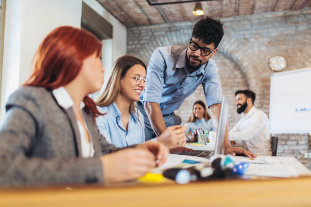 istock Business people working in office together. Team work in office. 1082098850