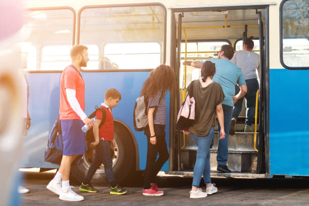 Group of people entering public transportation.