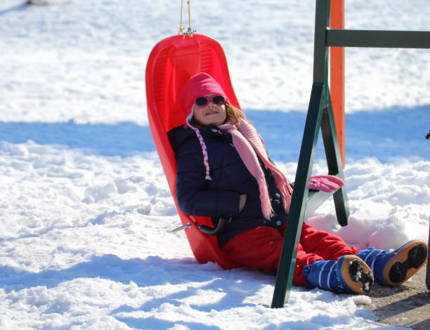istock little girl sitting inside the sled 1082098924