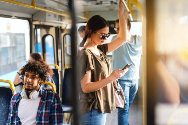 istock Caucasian girl driving in public bus and using smart phone for reading or writing message. 1082101270