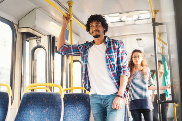 istock Smiling African American guy standing in the bus. 1082103734