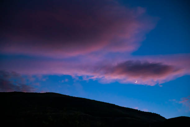 istock Moon with clouds at sunset in a growing phase 1082105180