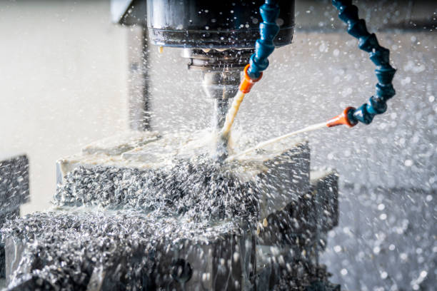istock CNC Machine tool cutting metal with coolant spray flying in a machine shop. 1082105982