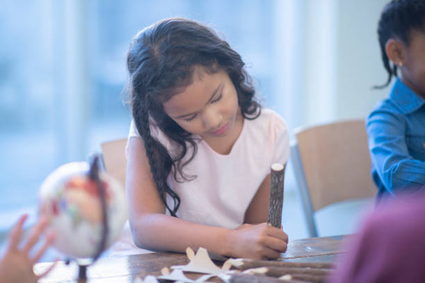 istock Little girl writing with a pencil 1082106136