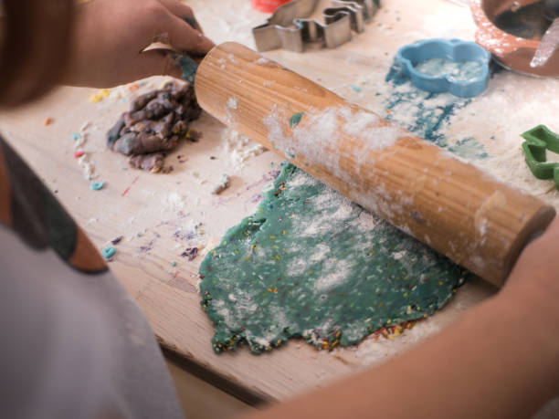 istock Christmas bakery: Little Girl rolling cookie dough 1082106580