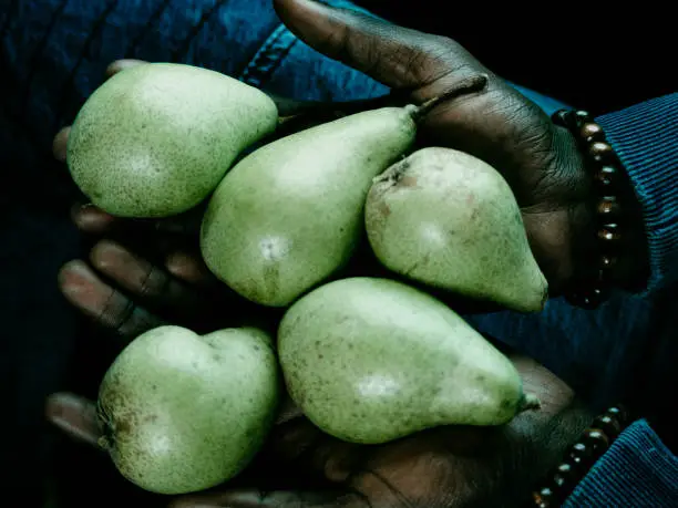 Young black man with pears in your hands. Top view