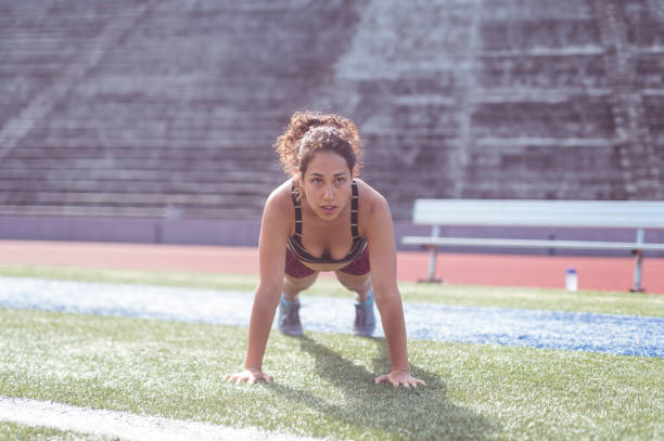 istock Female athlete cross trains on a stadium field 1082117216