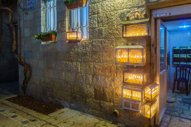 Traditional Menorahs with olive oil candles, Jewish quarter, Jerusalem Jerusalem, Israel - December 09, 2018: Traditional Menorahs (Hanukkah Lamps) with olive oil candles, placed near the entrance, in the Jewish quarter, Jerusalem Old City, Israel hanukkah candles stock pictures, royalty-free photos & images