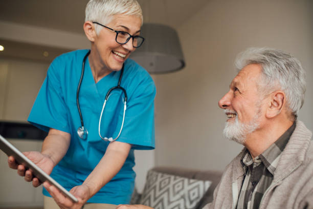 istock Happy nurse holding digital tablet 1082131584