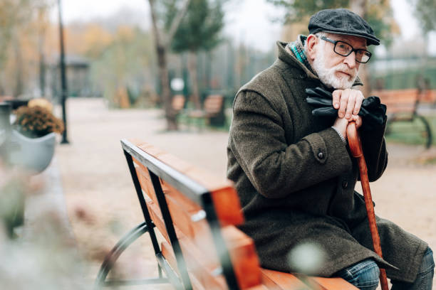 istock Thoughtful mature man leaning on walking stick 1082139626