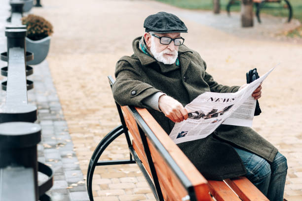 istock Attentive bearded man reading newspaper during walk 1082139642