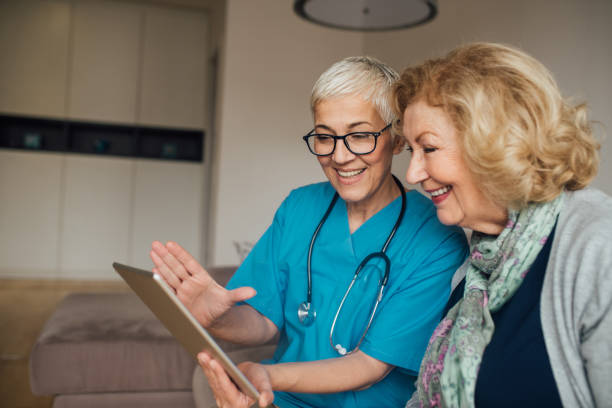 istock Happy mature women looking at digital tablet 1082139928