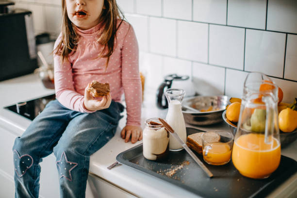 istock Messy girl in kitchen 1082156546