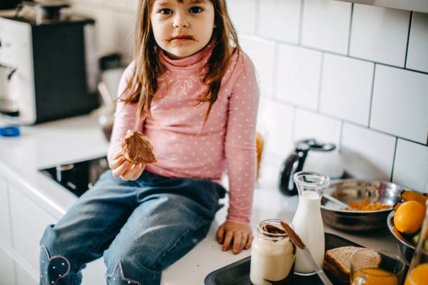 istock Messy girl in kitchen 1082163612
