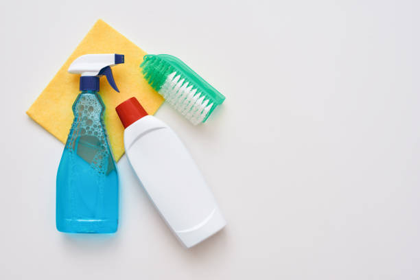 istock Cleaning tools. Spray bottle and orange cleaner cloth and brush isolated 1082169232