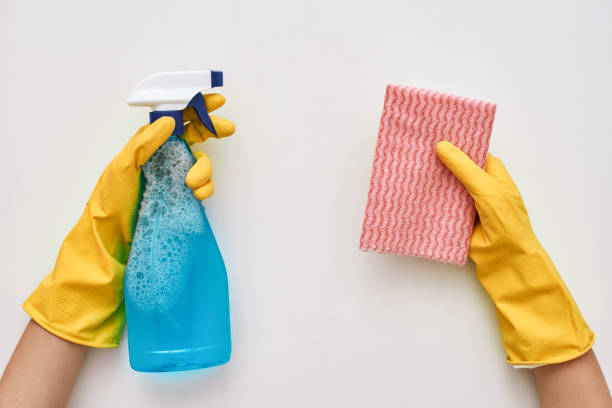 istock Keep cleaning. Glass cleaner and cloth in human hands 1082171566