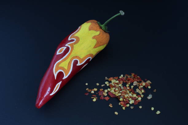 Red Chilli Pepper With Painted Fire On Black Craft Paper Background