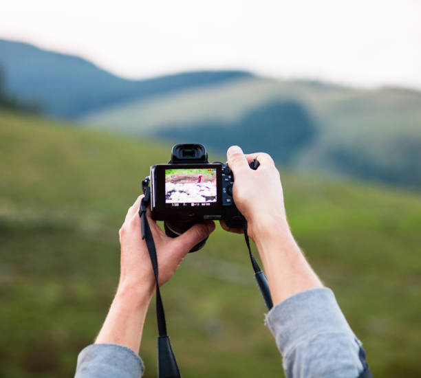 istock Hands holding the digital photo camera 1082182316