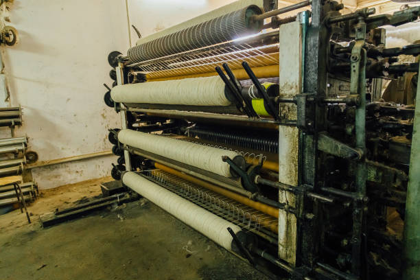 istock Wool thread production line. Spinning machinery with spindles and wool yarns 1082183366