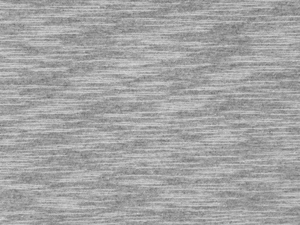 Heather gray t-shirt cotton knitted fabric Heather gray t-shirt cotton knitted fabric texture swatch heather grey stock pictures, royalty-free photos & images