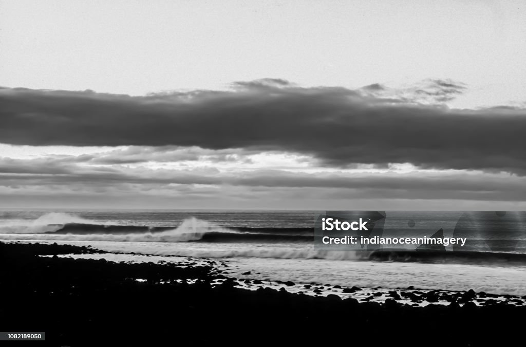 The Perfect Surfing Lineup of Waves in black and white at Raglan, New Zealad New Zealand Surfing Stock Photo