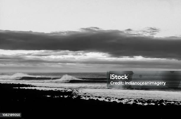 The Perfect Surfing Lineup Of Waves In Black And White At Raglan New Zealad Stock Photo - Download Image Now