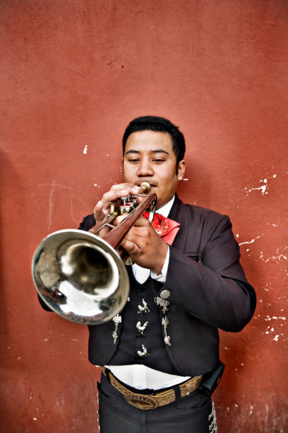 istock Mexican Mariachi Man Playing Trumpet Against Wall 108219133