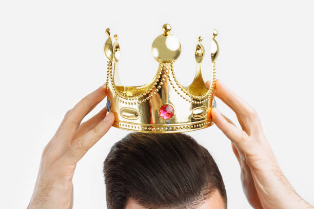 istock man on a white background wears a crown on his head, in a photo Studio 1082192174