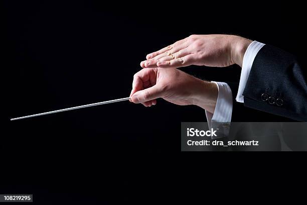 Closeup Of Orchestra Conductors Hands Isolated On Black Stock Photo - Download Image Now