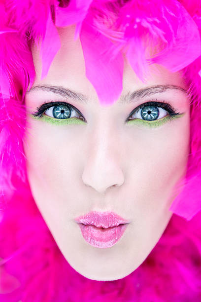 istock Young Woman's Face Wrapped in Pink Feather Boa 108219301