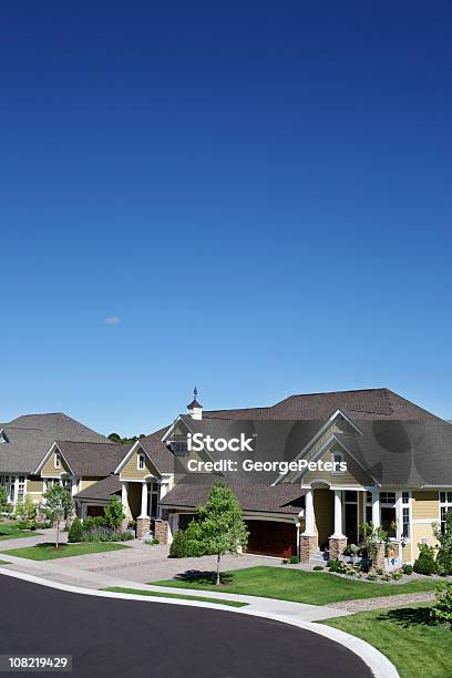 Suburban Street With Manicured Green Lawns And Blue Sky Stock Photo - Download Image Now