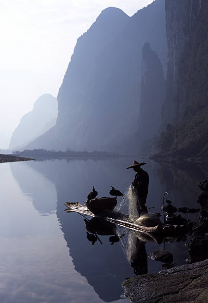 istock Fisherman and cormorants 108219430