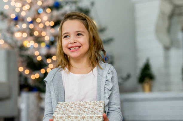 istock Smiling girl holding present 1082194318